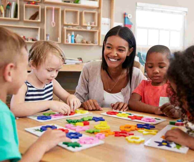 teacher with kids after taking Hand in Hand's trauma-informed training
