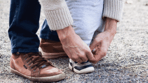 Tying toddler's shoe